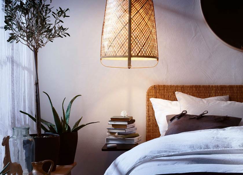 Bed with overhanging light and plants