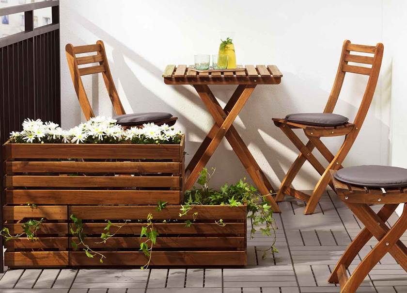 Wooden patio table and chairs and planter