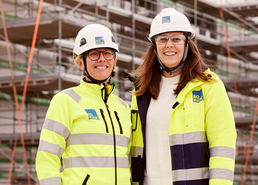 Two women in Hi-Vis safety jackets and safety helmets.