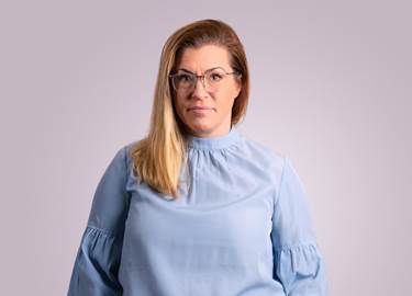 Woman in long blonde hari, with glasses and a light blue blouse Woman in long blonde hari, with glasses and a light blue blouse