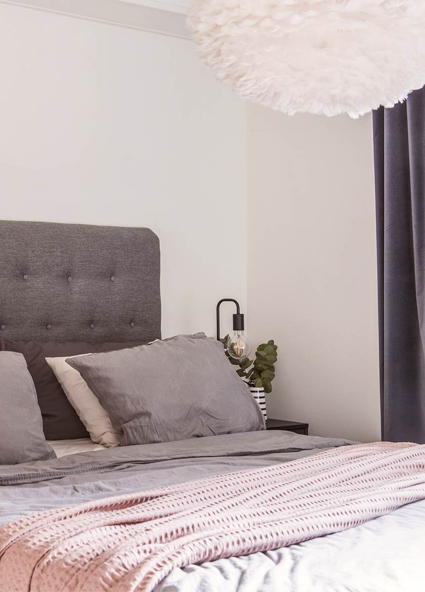 Bed with grey headboard and cushions Bed with grey headboard and cushions