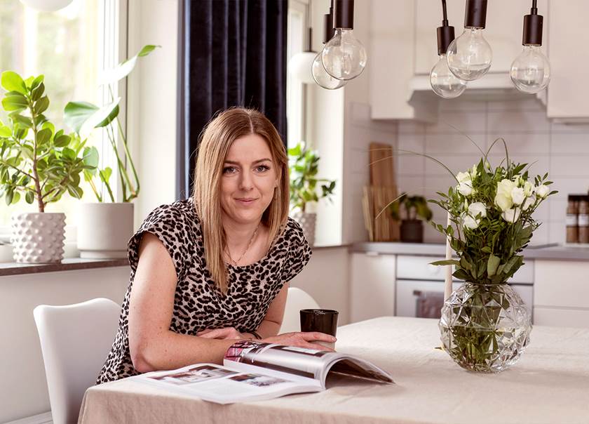 Blonde lady sat at dining table