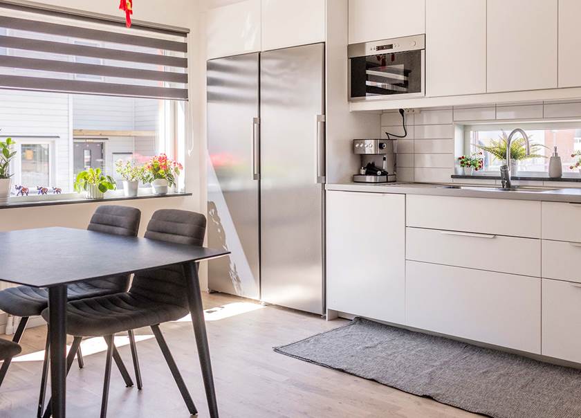 Kitchen with table and fridge freezer