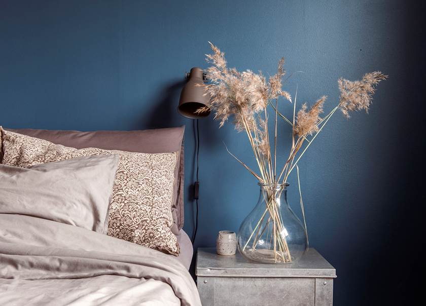 Bedroom with blue walls in the home of the Johansson-Jonsson family.