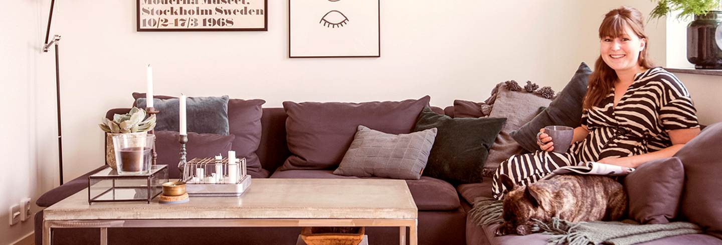 Woman sitting in a sofa with her dog. Woman sitting in a sofa with her dog.