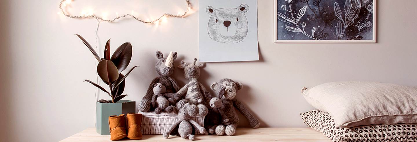 Shelf with stuffed animals in children's room.