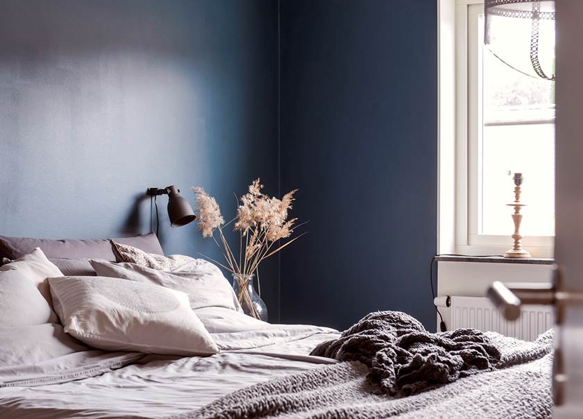 Bedroom with blue colored walls in the home of the Johansson-Jonsson family.
