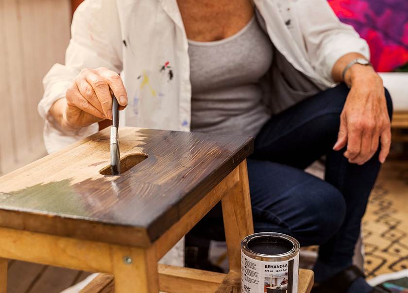 Lady painting an IKEA foot stall