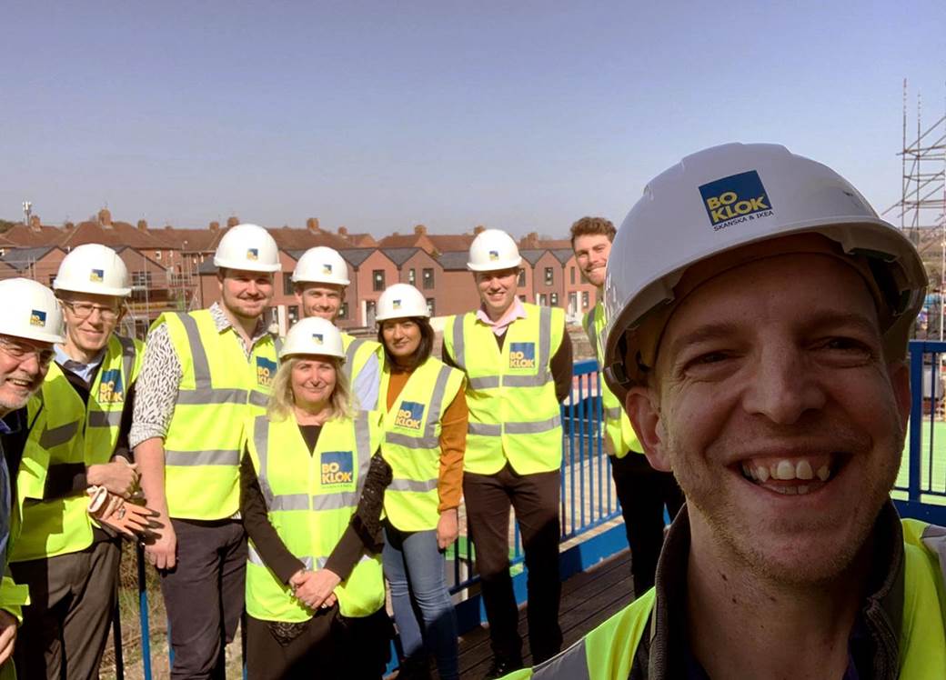 Team of site visitors in hard hats and high vis jackets