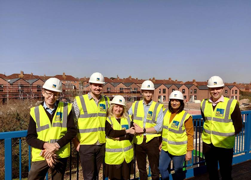 Group of site visitors in hard hats and high vis jackets