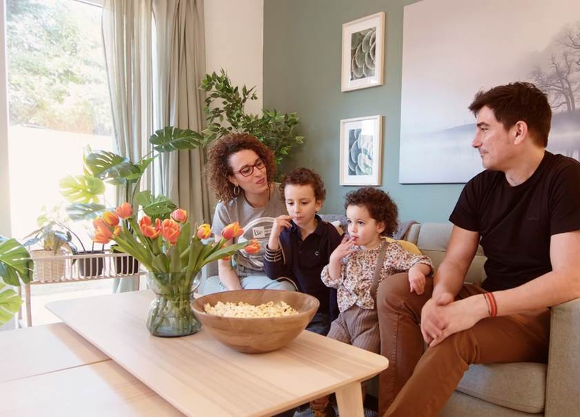 Family sat together on the sofa