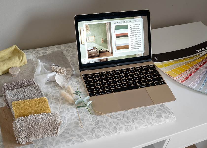Laptop on desk with color sample.