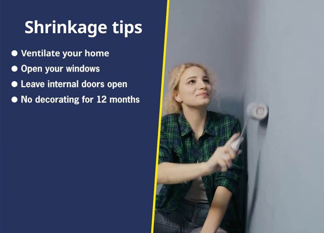 Woman painting a wall next to shrinkage tips.