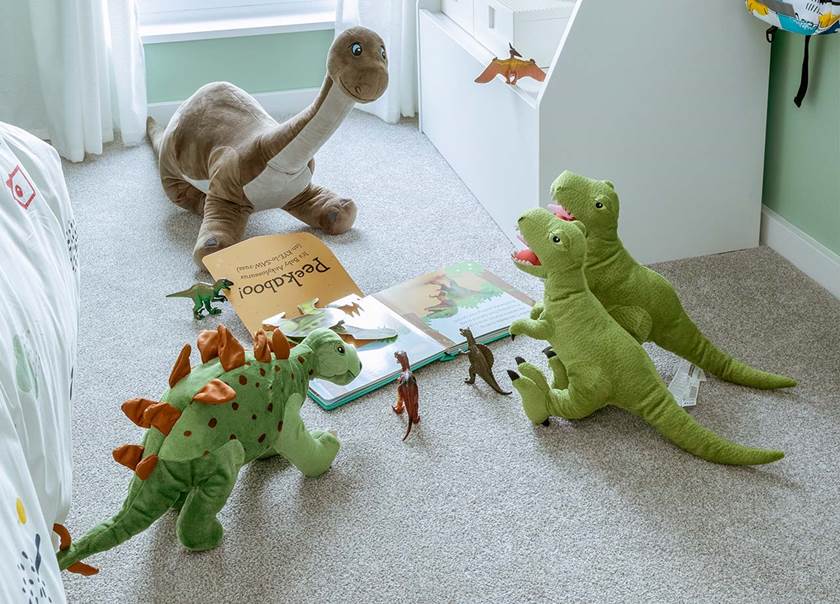 Dinosaurs stuffed animals on the floor in children's room