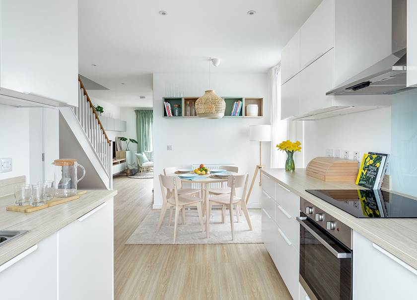 Kitchen with table and four chairs in new BoKlok home.