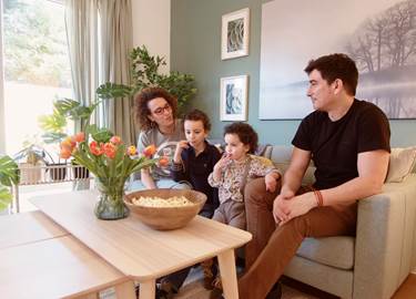 Family sat on sofa Family sat on sofa