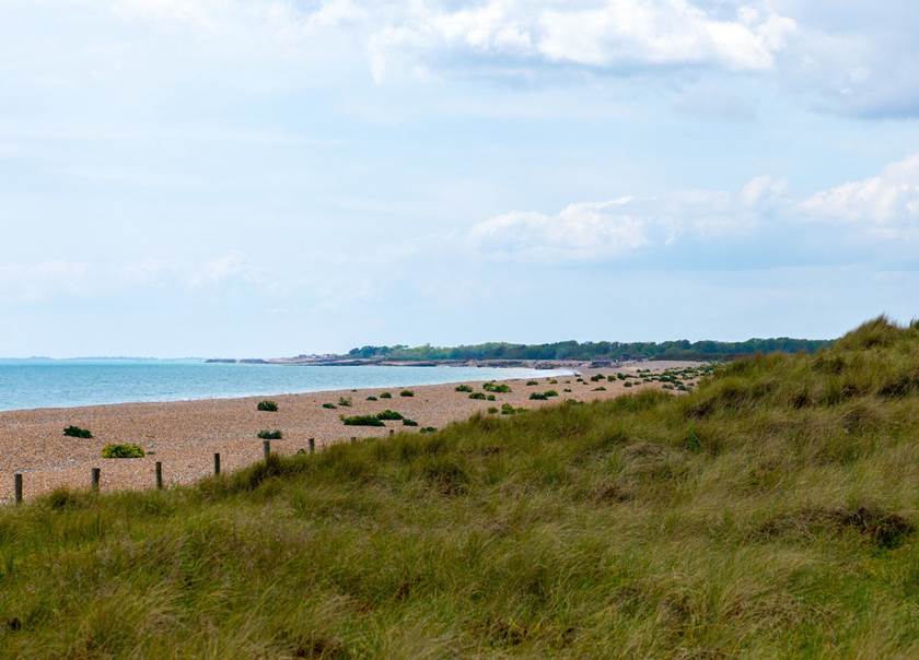 View of a beach in a slightly cloudy day. View of a beach in a slightly cloudy day.