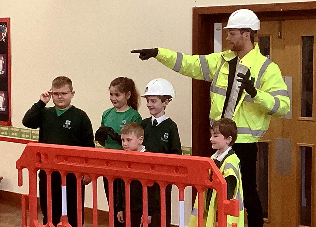 BoKlok team member in high vis and hard hat with school children